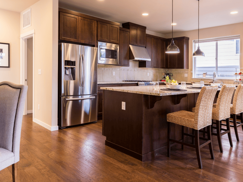 Kitchen with warm hardwood flooring installed in Orillia, ON