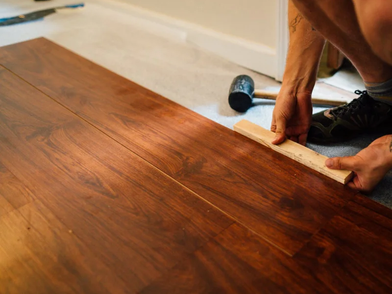 Flooring contractor installing a hardwood floor in Barrie, ON